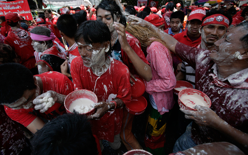 Anti-government 'red shirt' protesters apply powder on each other's faces as they celebrate the Songkran festival that marks the Thai new year in the main shopping district in Bangkok on April 13. (Reuters)