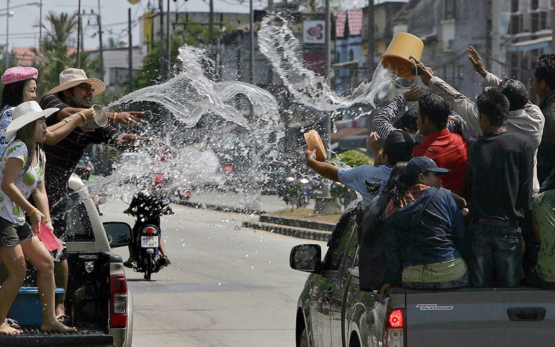 Thai people celebrate the Songkran festival marking the Thai new year in Thailand's southern province of Narathiwat on April 13. Songkran marks the summer season in Thailand, where families and friends celebrate the festival by visiting temples and splashing water on each other's hands as an act of wishing good luck. (AFP)