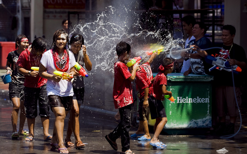 People spray each other with water guns during the Songkran festival to mark the Thai new year along the tourist area of Khao San road in Bangkok on April 13. Songkran marks the summer season in Thailand, where families and friends celebrate the festival by visiting temples and splashing water on each other's hands as an act of wishing good luck. (AFP)