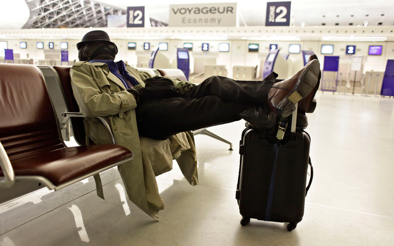 A passenger rests at Roissy Charles de Gaulle Airport, as hundreds of commercial flights across northern Europe are canceled due to a drifting plume of volcanic ash originating from Iceland, outside Paris, on April 18. The Icelandic volcano that has kept much of Europe land-bound is far from finished spitting out its grit, and offered up new mini-eruptions that raise concerns about longer-term damage to world air travel and trade. (AP)