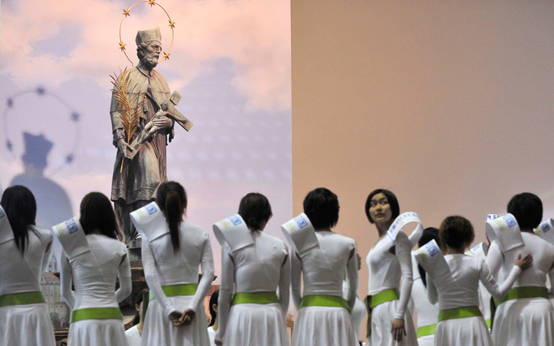 Volunteers stand near a replica of Prague's Saint John of Nepomuk statue inside the Czech pavilion at the Shanghai World Expo 2010 site on April 19. The original statue is found on the medieval Charles Bridge in Prague. (Reuters)