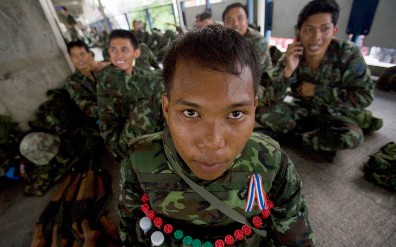 Thai army soldiers rest on a walkway near a skytrain station in the Silom Road financial district in Bangkok on April 19. Thai soldiers patrolled Bangkok's business district on Monday to keep thousands of anti-government protesters from marching there, raising fears of fresh violence in the polarised country. (Reuters)