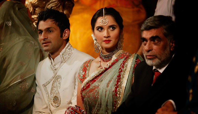 Newly wed couple Pakistani Cricketer Shoaib Malik and his wife Indian tennis star Sania Mirza pose for photograph during their wedding reception in Sialkot, Pakistan on Sunday, April 25. The couple married last week in a ceremony that took place in the hotel at Mirza's hometown of Hyderabad, India. (AP)