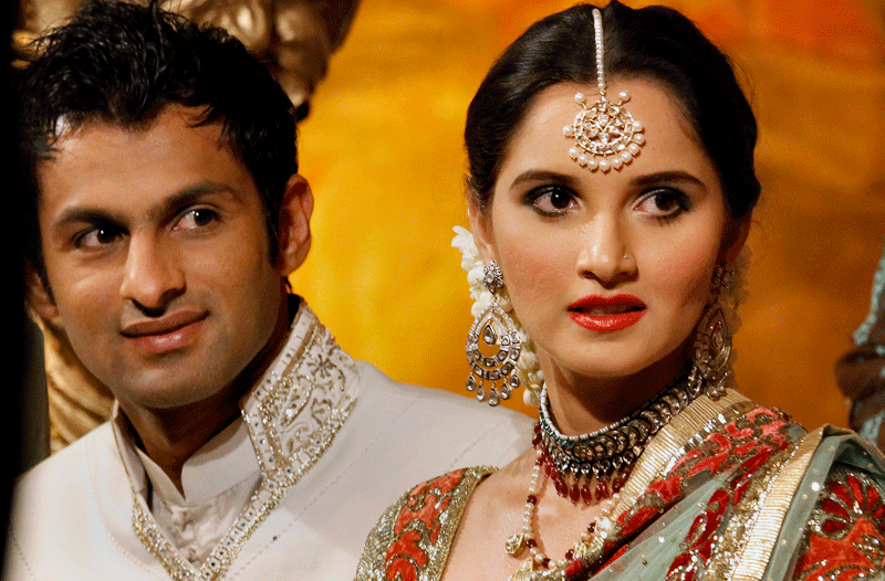 Newly wed couple Pakistani Cricketer Shoaib Malik and his wife Indian tennis star Sania Mirza looks on during their wedding reception in Sialkot, Pakistan on Sunday, April 25. The couple married last week in a ceremony that took place in the hotel at Mirza's hometown of Hyderabad, India. (AP)