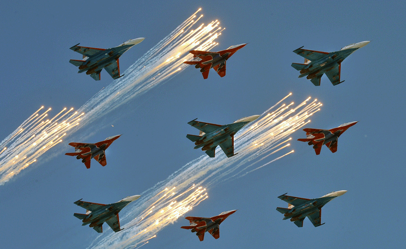 Russian Su-27 and MiG-29 fighter jets shoot flares while flying over St. Basil's Cathedral on Red Square in Moscow on during a Victory Day parade on May 9, 2010. Troops from four NATO states marched through Red Square for the first time as Russia marked victory in World War II with its biggest military parade since the collapse of the Soviet Union. (AFP)