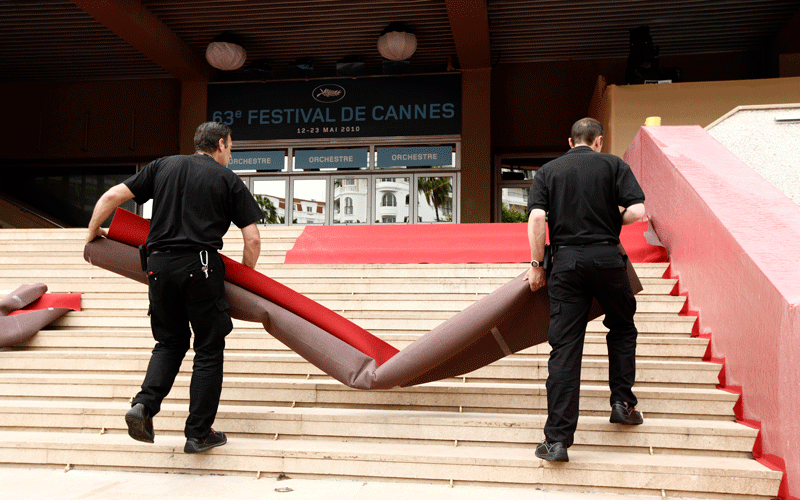 Workers prepare the red carpet on the steps of the Palais prior to the start of the 63rd international film festival, in Cannes, southern France on May 12, 2010. (AP)