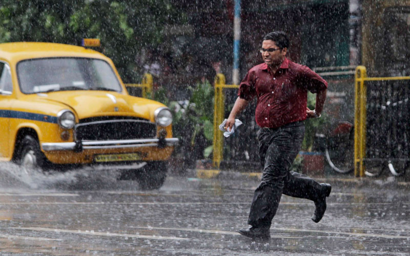 A man runs for shelter during a sudden down pour in Calcutta, India. India's monsoon rains, the main source of irrigation for the nation's 235 million farmers, is 6 per cent below average so far according to the Indian Meteorological Department. (AP)