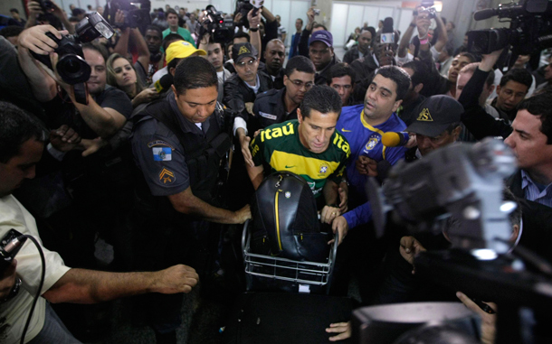 Brazil's assistant coach Jorginho (C) is escorted by police after arriving at Internacional Airport in Rio de Janeiro. Brazil's national soccer team arrived back in Rio after losing to the Netherlands at the 2010 World Cup in South Africa. (REUTERS)