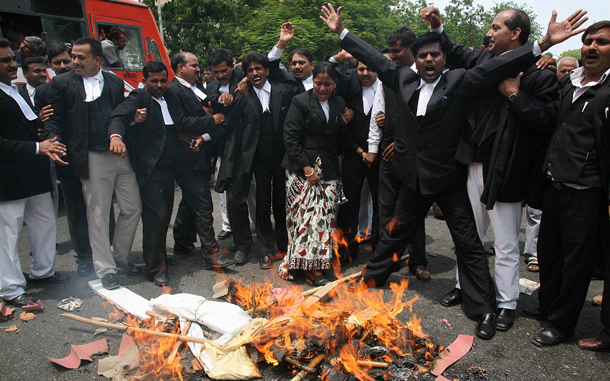 Lawyers shout slogans as they burn an effigy of Indian Prime Minister Manmohan Singh during a strike in the northern Indian city of Allahabad. Many flights were cancelled and trucks stayed off the roads in India in response to a day-long strike called by opposition parties to protest fuel price hikes they say will add to double-digit inflation. (REUTERS)