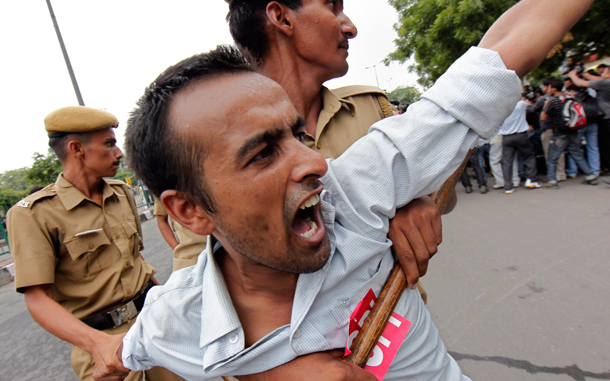 Police arrest an activist of the opposition Communist Party of India (Marxist) during a strike against the hike in fuel prices in New Delhi. Many flights were cancelled and trucks stayed off the roads in India on Monday in response to a day-long strike called by opposition parties to protest fuel price hikes they say will add to double-digit inflation. (REUTERS)