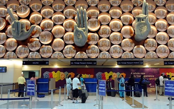 Passengers on an Air India flight from New York pass through immigration counters at terminal T-3 of Indira Gandhi International airport in New Delhi. An Air India plane carrying more than 200 passengers from New York became the first commercial flight to land at New Delhi's new, 2.7-billion-dollar airport terminal. (AFP)