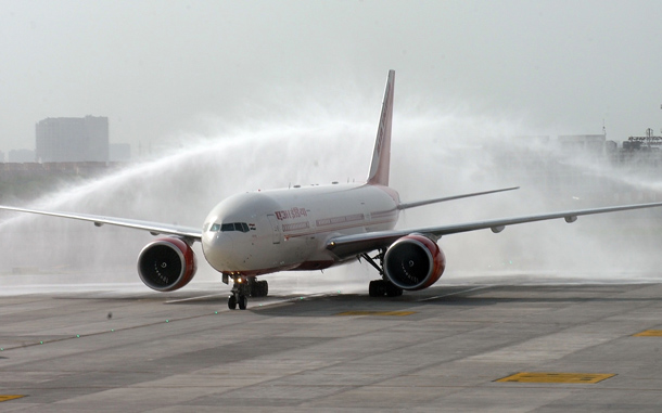 An Air India aircraft from New York is given a water cannon salute on its arrival at Indira Gandhi International airport's terminal T-3 in New Delhi. An Air India plane carrying more than 200 passengers from New York became Wednesday the first commercial flight to land at New Delhi's new, 2.7-billion-dollar airport terminal. (AFP)