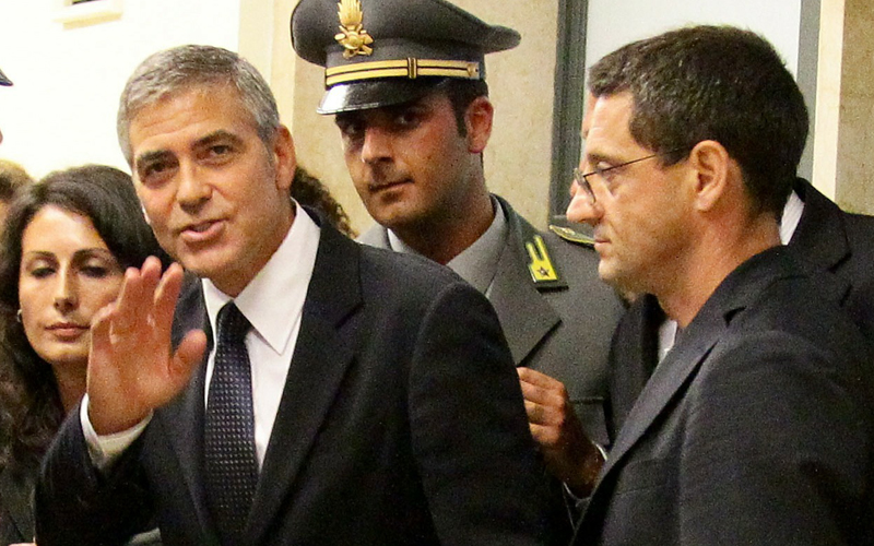 Clooney waves to fans outside Milan's Law court. He said images of him presented in court were false, telling the accused that they had done "very good work". (REUTERS)