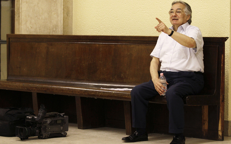 Vincenzo Cannalire gestures at the tribunal in Milan on Friday. Cannalire, Vanja Goffi and Francesco Galdelli have been charged with using George Clooney's name without the actor's permission. (AP)