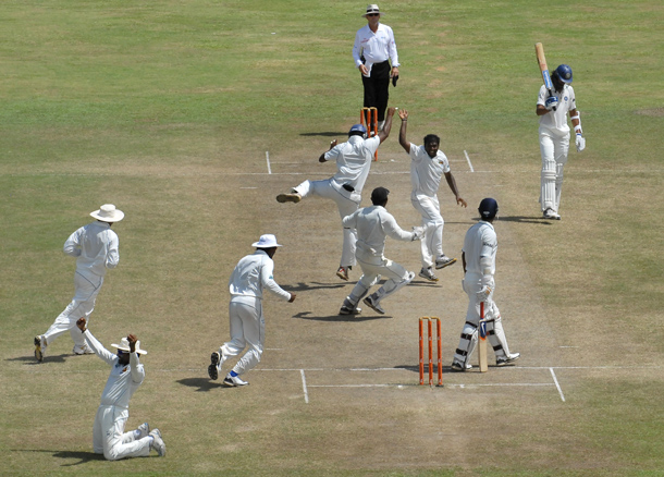 Sri Lankan cricketer Muttiah Muralitharan (CR) celebrates with teammates on claiming his 800th Test wicket with the dismissal of Indian cricketer Pragyan Ojha (2R) during the fifth and final day of the first cricket Test match between Sri Lanka and India at The Galle International Cricket Stadium in Galle. Retiring world bowling record holder Muttiah Muralitharan of Sri Lanka reached the 800-wicket mark with his last delivery in Test cricket.  The off-spinner, 38, had last man Pragyan Ojha caught at slip by Mahela Jayawardene to terminate India's second innings after lunch on the final day of the first Test at the Galle International Stadium. India, who were made to follow on 244 runs behind, were all out for 338 in their second knock. (AFP)