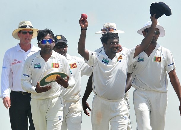 Sri Lankan cricketer Muttiah Muralitharan (2R) holds up the cricket ball as he walks back to the pavilion with teammates at the end of India's second innings during the fifth and final day of the first cricket Test match between Sri Lanka and India at The Galle International Cricket Stadium in Galle. Retiring world bowling record holder Muttiah Muralitharan of Sri Lanka reached the 800-wicket mark with his last delivery in Test cricket. The off-spinner, 38, had last man Pragyan Ojha caught at slip by Mahela Jayawardene to terminate India's second innings after lunch on the final day of the first Test at the Galle International Stadium. India, who were made to follow on 244 runs behind, were all out for 338 in their second knock. (AFP)