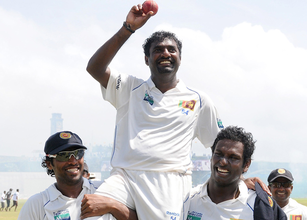 Sri Lankan cricketer Muttiah Muralitharan (C) holds up the cricket ball as he is carried on the shoulders of his team mates Chanaka Welegedara (L) and Angelo Mathews (R) in a lap of honour around the pitch at the end of India's second innings during the fifth and final day of the first cricket Test match between Sri Lanka and India at The Galle International Cricket Stadium in Galle. Retiring world bowling record holder Muttiah Muralitharan of Sri Lanka reached the 800-wicket mark with his last delivery in Test cricket. The off-spinner, 38, had last man Pragyan Ojha caught at slip by Mahela Jayawardene to terminate India's second innings after lunch on the final day of the first Test at the Galle International Stadium. India, who were made to follow on 244 runs behind, were all out for 338 in their second knock. (AFP)