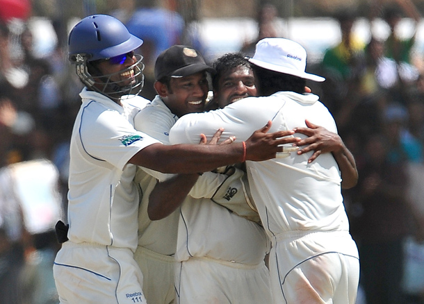 Sri Lankan cricketer Muttiah Muralitharan (2R) celebrates with teammates on claiming his 800th Test wicket with the dismissal of Indian cricketer Pragyan Ojha during the fifth and final day of the first cricket Test match between Sri Lanka and India at The Galle International Cricket Stadium in Galle. Retiring world bowling record holder Muttiah Muralitharan of Sri Lanka reached the 800-wicket mark with his last delivery in Test cricket. The off-spinner, 38, had last man Pragyan Ojha caught at slip by Mahela Jayawardene to terminate India's second innings after lunch on the final day of the first Test at the Galle International Stadium. India, who were made to follow on 244 runs behind, were all out for 338 in their second knock. (AFP)