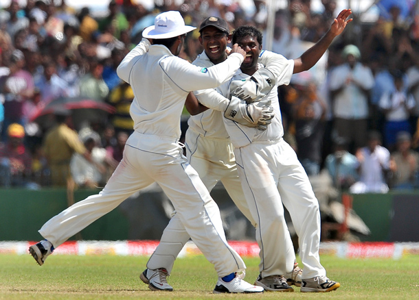 Sri Lankan cricketer Muttiah Muralitharan (R) celebrates with teammates on claiming his 800th Test wicket with the dismissal of Indian cricketer Pragyan Ojha during the fifth and final day of the first cricket Test match between Sri Lanka and India at The Galle International Cricket Stadium in Galle. Retiring world bowling record holder Muttiah Muralitharan of Sri Lanka reached the 800-wicket mark with his last delivery in Test cricket. The off-spinner, 38, had last man Pragyan Ojha caught at slip by Mahela Jayawardene to terminate India's second innings after lunch on the final day of the first Test at the Galle International Stadium. India, who were made to follow on 244 runs behind, were all out for 338 in their second knock. (AFP)