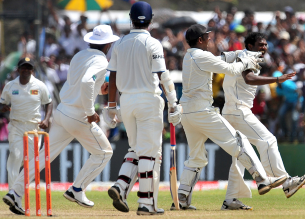 Sri Lankan cricketer Muttiah Muralitharan celebrates with teammates on claiming his 800th Test wicket with the dismissal of Indian cricketer Pragyan Ojha during the fifth and final day of the first cricket Test match between Sri Lanka and India at The Galle International Cricket Stadium in Galle. Retiring world bowling record holder Muttiah Muralitharan of Sri Lanka reached the 800-wicket mark with his last delivery in Test cricket. The off-spinner, 38, had last man Pragyan Ojha caught at slip by Mahela Jayawardene to terminate India's second innings after lunch on the final day of the first Test at the Galle International Stadium. India, who were made to follow on 244 runs behind, were all out for 338 in their second knock. (AFP)