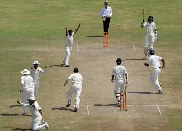 Sri Lankan cricketer Muttiah Muralitharan (CL) celebrates with teammates on claiming his 800th Test wicket with the dismissal of Indian cricketer Pragyan Ojha (3R) during the fifth and final day of the first cricket Test match between Sri Lanka and India at The Galle International Cricket Stadium in Galle on. Retiring world bowling record holder Muttiah Muralitharan of Sri Lanka reached the 800-wicket mark with his last delivery in Test cricket. The off-spinner, 38, had last man Pragyan Ojha caught at slip by Mahela Jayawardene to terminate India's second innings after lunch on the final day of the first Test at the Galle International Stadium. India, who were made to follow on 244 runs behind, were all out for 338 in their second knock. (AFP)