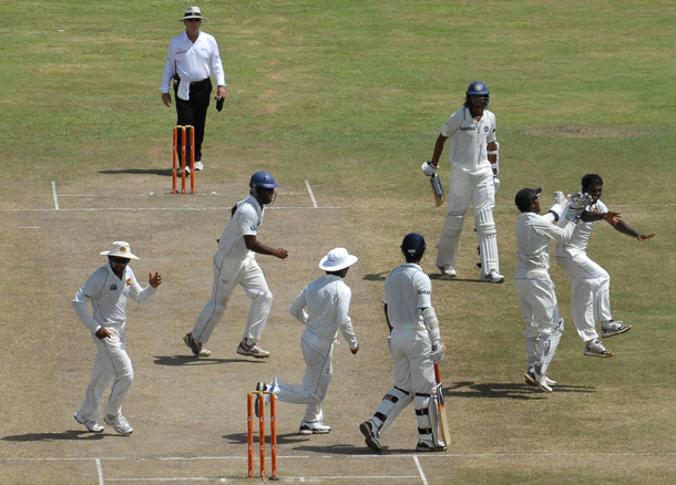 Sri Lankan cricketer Muttiah Muralitharan (R) celebrates with teammates on claiming his 800th Test wicket with the dismissal of Indian cricketer Pragyan Ojha (4R) during the fifth and final day of the first cricket Test match between Sri Lanka and India at The Galle International Cricket Stadium in Galle. Retiring world bowling record holder Muttiah Muralitharan of Sri Lanka reached the 800-wicket mark with his last delivery in Test cricket. The off-spinner, 38, had last man Pragyan Ojha caught at slip by Mahela Jayawardene to terminate India's second innings after lunch on the final day of the first Test at the Galle International Stadium. India, who were made to follow on 244 runs behind, were all out for 338 in their second knock. (AFP)