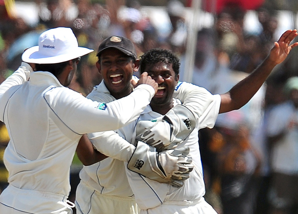 Sri Lankan cricketer Muttiah Muralitharan (R) celebrates with teammates on claiming his 800th Test wicket with the dismissal of Indian cricketer Pragyan Ojha during the fifth and final day of the first cricket Test match between Sri Lanka and India at The Galle International Cricket Stadium in Galle. Retiring world bowling record holder Muttiah Muralitharan of Sri Lanka reached the 800-wicket mark with his last delivery in Test cricket. The off-spinner, 38, had last man Pragyan Ojha caught at slip by Mahela Jayawardene to terminate India's second innings after lunch on the final day of the first Test at the Galle International Stadium. India, who were made to follow on 244 runs behind, were all out for 338 in their second knock. (AFP)