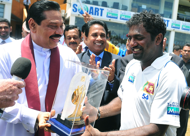 Sri Lankan President Mahinda Rajapaksa (L) presents a memento to cricketer Muttiah Muralitharan (R) during the fifth day of the first Test match between Sri Lanka and India at The Galle International Cricket Stadium in Galle. Hosts Sri Lanka were well-placed to win the first Test against India after spin wizard Muttiah Muralitharan wreaked havoc in his final match. The world's leading wicket-taker grabbed 5-63 in the first innings as India were forced to follow on after being shot out for 276 on the fourth day in reply to Sri Lanka's 520-8 declared. Sling-arm fast bowler Lasith Malinga then claimed three wickets to leave the tourists' second innings tottering at 181-5 at stumps, still 63 runs away from avoiding an innings defeat. (AFP)