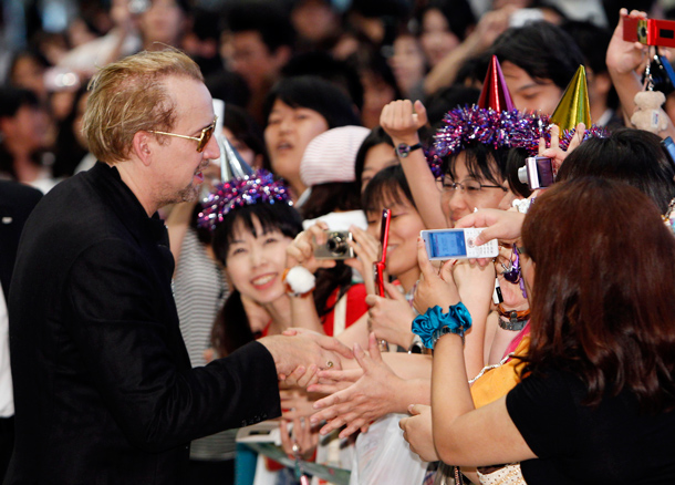 Actor Nicolas Cage greets fans upon his arrival at Narita International Airport in Narita, east of Tokyo. Cage is here to promote his new film “The Sorcerer’s Apprentice.” (AP)