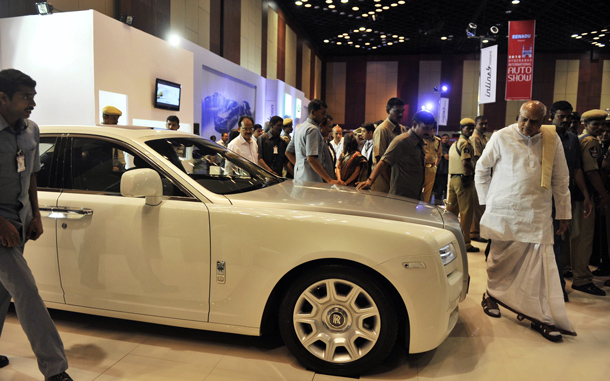 Chief Minister of the Indian state of Andhra Pradesh K.Rosaiah (R) looks at a Rolls-Royce Ghost Saloon on display at The Hyderabad International Auto Show 2010 at The Hyderabad International Convention Centre (HICC) in Hyderabad. The Ghost is the first in a new series of Rolls-Royce models costs approximately Indian Rupees 25000000 (USD 530,266). (AFP)