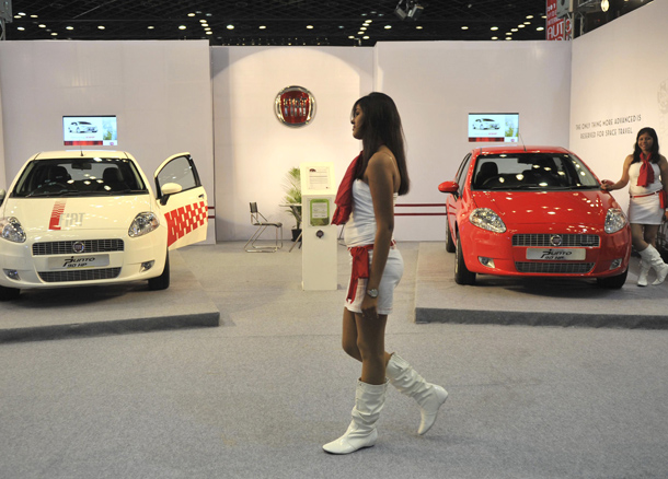 Indian models pose beside Fiat Grande Punto 90 HP Multijet cars on display at The Hyderabad International Auto Show 2010 at The Hyderabad International Convention Centre (HICC) in Hyderabad. The Multijet will cost approximately Indian Rupees 693000 (USD 14,700). (AFP)