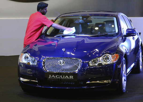 An Indian worker polishes a Jaguar car on display at The Hyderabad International Auto Show 2010 at The Hyderabad International Convention Centre (HICC) in Hyderabad. The event in the southern Indian city will continue until July 25. (AFP)