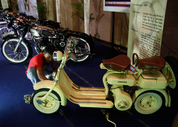 A man cleans a Lambretta two wheeler displayed at the Hyderabad International Auto Show in Hyderabad, India. (AP)