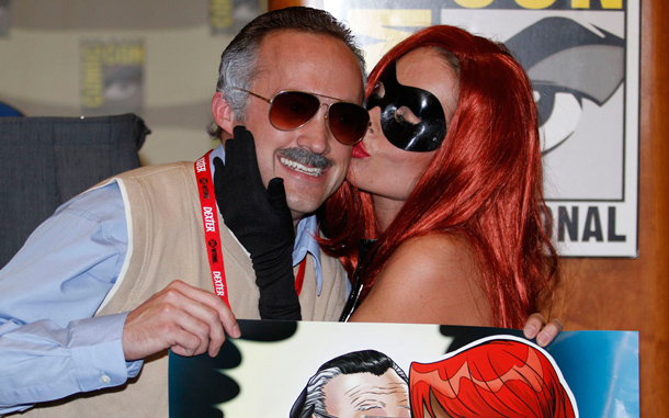 Stan Lee impersonator Kevin McShane gets a kiss from model Courtney Black during a panel for comic creator Stan Lee at Comic-Con. (AP)