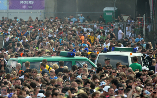 Hundreds of thousands of people walk to the Love Parade festival, near the site where at least 18 people were later crushed to death and dozens injured in a stampede, Duisburg, Germany. (GETTY IMAGES)