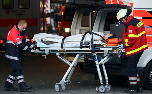 Paramedics transport an injured person to an ambulance after at least 15 people were crushed to death and dozens injured in a stampede at Germany's famous Love Parade festival in Duisburg, Germany. Thousands of other revelers kept partying at the event unaware of the deadly stampede that started when police tried to block thousands more people from entering the already-jammed parade grounds. (GETTY IMAGES)