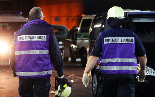 An emergency pastor arrives at the scene of the accident after at least 15 people were crushed to death and dozens injured in a stampede at Germany's famous Love Parade festival in Duisburg, Germany. Thousands of other revelers kept partying at the event unaware of the deadly stampede that started when police tried to block thousands more people from entering the already-jammed parade grounds. (GETTY IMAGES)