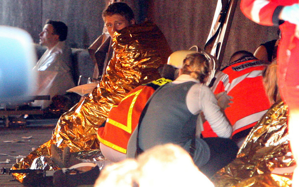 Festival-goers are attended to by paramedics in a tunnel at the scene of a stampede in which at least 15 people were crushed to death and dozens injured at Germany's famous Love Parade festival in Duisburg, Germany. Thousands of other revelers kept partying at the event unaware of the deadly stampede that started when police tried to block thousands more people from entering the already-jammed parade grounds. (GETTY IMAGES)