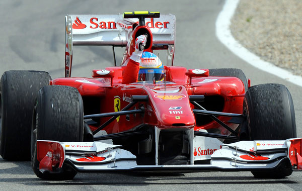 Fernando Alonso celebrates in his car in front of Ferrari's Brazilian driver Felipe Massa at the Hockenheimring circuit in Hockenheim, after the Formula One German Grand Prix. (AFP)