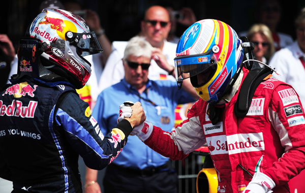 Ferrari's Spanish driver Fernando Alonso (R) is congratulated by Red Bull's German driver Sebastian Vettel in the parc ferme of the Hockenheimring circuit in Hockenheim, after the Formula One German Grand Prix. (AFP)