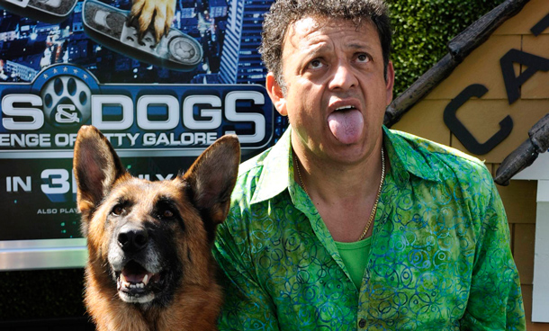 Cast member Paul Rodriguez poses with a German Shepherd dog as he attends the premiere of the film "Cats & Dogs, The Revenge of Kitty Galore" in Los Angeles. (REUTERS)