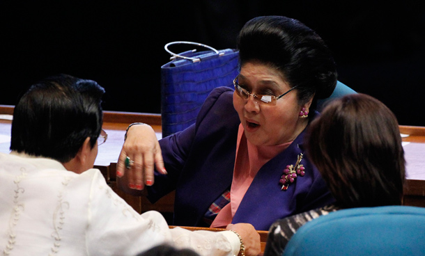 Former Philippine First Lady and Congresswoman Imelda Marcos talks to colleagues during the opening of the 15th Philippine congress in Quezon city, Metro Manila. Philippine President Benigno Aquino III will outline his political agenda when Congress sits on Monday for the first time since the May election, and analysts hope he uses the platform to move beyond his campaign rhetoric. (REUTERS)