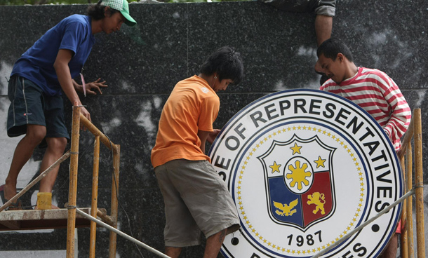 Filipino workers put up a logo of the House of Representatives in Quezon City, east of Manila, Philippines. President Benigno Aquino III, son of the late president Corazon Aquino, is set to deliver on 26 July his first State of the Nation Address (SONA) to the country at the House of Representatives at the opening of the 15th Congress less than a month since taking his oath of office. (EPA)