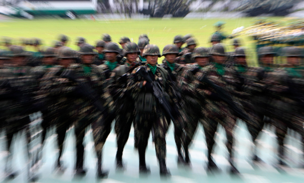 Army troopers march in honor of the new Philippine Army chief Lt.Gen. Arturo Ortiz (unseen) during the turnover of command ceremony at Fort Bonifacio parade grounds, south of Manila in the Philippines. In addressing the troops, President Benigno Aquino III, whose late mother Corazon Aquino survived seven coup attempts during her term as President, expressed confidence no more coup attempts will be carried out during his administration. (AP)