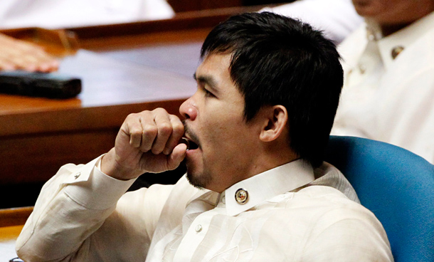 Newly elected Philippine congressman and world boxing champion Manny Pacquiao yawns during the opening ceremony of the 15th Philippine Congress in Quezon City, Metro Manila. Philippine President Benigno Aquino III will outline his political agenda when Congress sits on Monday for the first time since the May election, and analysts hope he uses the platform to move beyond his campaign rhetoric. (REUTERS)