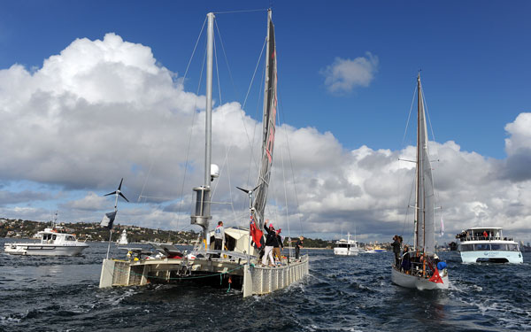 The 'Plastiki', a boat made from 12,500 plastic bottles, completes her 8,000-nautical mile trans-Pacific voyage from San Francisco as she enters Sydney Harbour. (AFP)