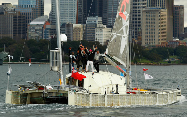 British adventurer and environmentalist David de Rothschild sails as the "Plastiki" arrives at Sydney Harbour, completing the 12,860 kilometre journey from San Francisco to raise environmental awareness in Sydney, Australia. (GETTY IMAGES)