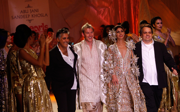 Indian designers Abu Jani, second left, and Sandeep Khosla, right, walk the ramp with Australian cricketer Brett Lee, centre, and socialite Shweta Bachchan Nanda during Delhi Couture Week. (AP)