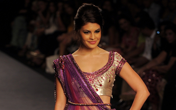 Sri Lankan Bollywood actress Jacquline Fernandez presents a creation by Indian designer Rakesh Agarvwal during the Pearls Delhi Couture Week 2010. (AFP)