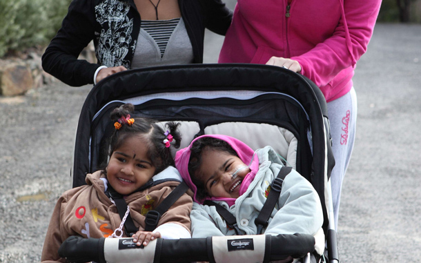 Formerly conjoined twins  Krishna (front R) and Trishna (front L) being re-united with their biological mother. (AFP)